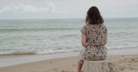 The girl is sitting on the beach Stock Footage 133721383