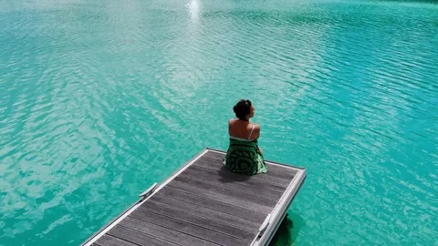 The girl is sitting on the pier. Stock Footage 101976434