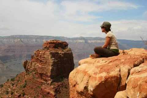 Girl Sitting on Rock Looking at Grand Canyon Stock Photos