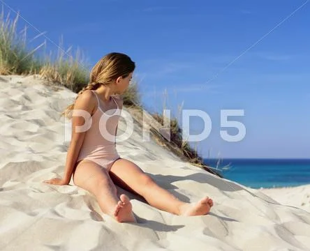 Girl Sitting On A Sand Dune