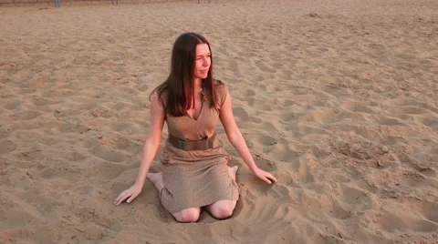 Girl sitting on the sand Stock Footage