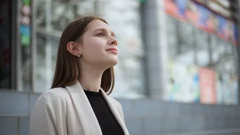 The girl is sitting on the steps, looking up Stock-Footage 114529281