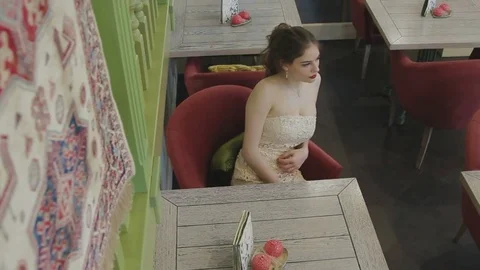 Girl sitting at the table Stock Footage 73034193