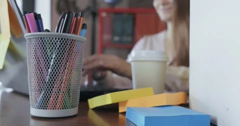 Girl sitting at table, freelancer working at home, abstract plan, out of focus Stock Footage 131005130
