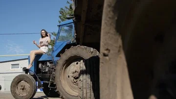 Girl Sitting on a Tractor Stock Footage 85484495