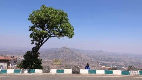 Girl sitting under a tree alone Stock Footage 87664225