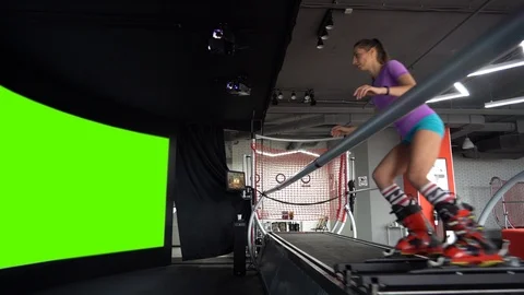 A girl skier is riding a simulation simulating a ski run. Stock Footage 123699934