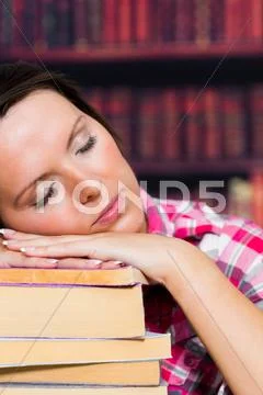 Girl sleeping on books Stock Photos