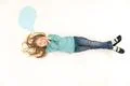 The girl sleeping on the floor near the dialog sign. View from above Photo