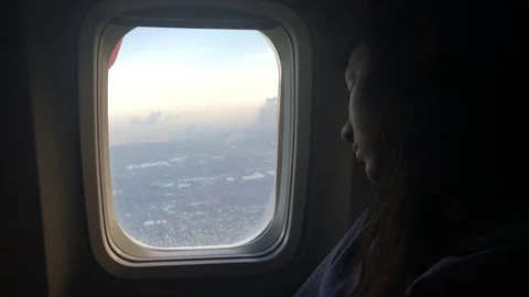 Girl sleeping by an open airplane window Stock Footage 79733213