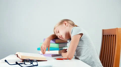 Girl sleeping on stack of books and wakes up Stock Footage 65305249