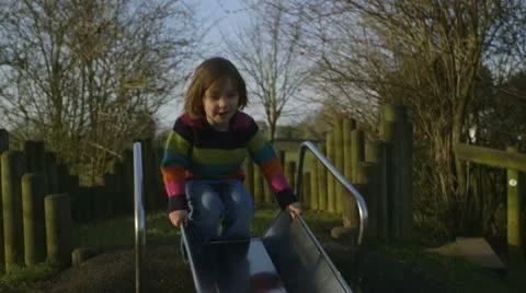 Girl sliding down slide Stock Footage 22226344