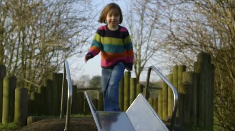 Girl sliding down slide forwards Stock Footage 22226464