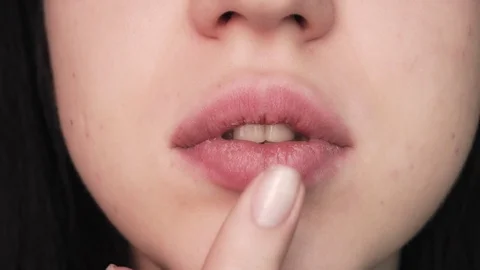 Girl smears ointment lips. Dry skin in the cold season. Vídeos de archivo 121572953