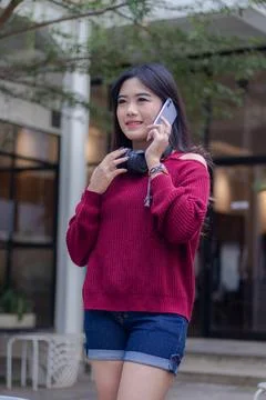 Girl smiling casually posing standing and calling in cafe oudoor Stock Photos