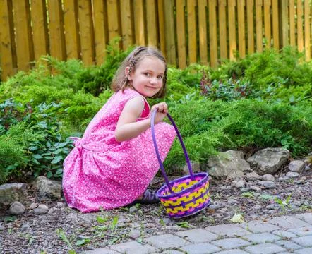 Girl Smiling During an Easter Egg Hunt Stock Photos