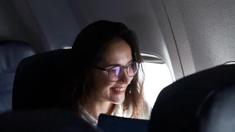 Girl smiling while sitting in the plane Stock Footage 111149658