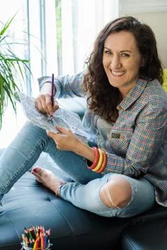 Girl smiling while working on creative art hobby Stock Photos