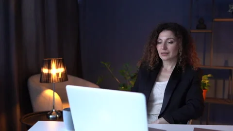 Girl smiling while working in the office on a laptop. Adult attractive brunette Stock Footage 155940033