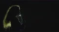 The girl smoke electronic cigarette on the dark background. Slow motion capture 4k or 4k+ Resolution