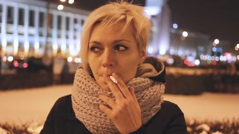 The girl smokes a cigarette, front view. Night in the city, outdoor, exterior, r Stock Footage 85428362