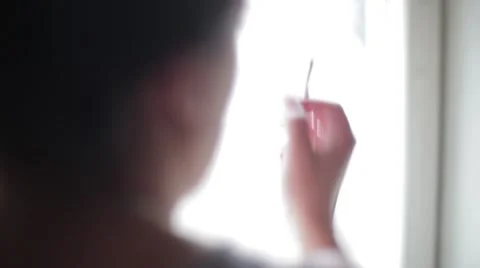 The girl smokes near the window Stock Footage 59798403
