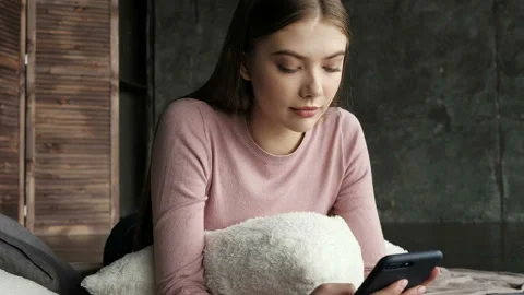 Girl sms texting using app on smart phone at home. Stock Footage 88602940