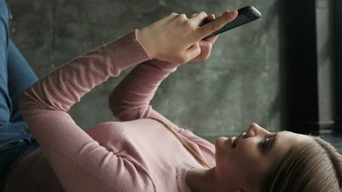 Girl sms texting using app on smart phone at home. Stock Footage 88603174