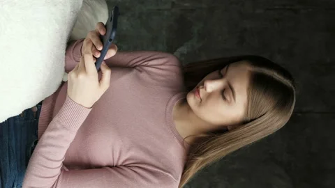 Girl sms texting using app on smart phone at home. Stock Footage 88604073