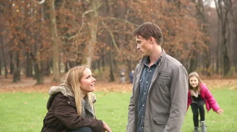 Girl sneaking up to her parents and surprising them Stock Footage 59554154