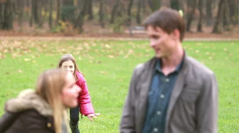 Girl sneaking up to her parents and surprising them Stock Footage 59554561