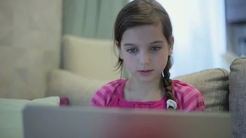 A girl on the sofa is educating herself on a laptop close up Stock Footage 73358982