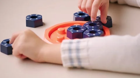 Girl solving logic puzzle, Children hands playing with educational math STE.. Stock Footage 318894887