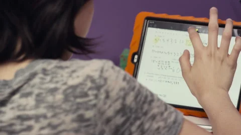 Girl solving mathematic problem on digital tablet Stock Footage 63861737