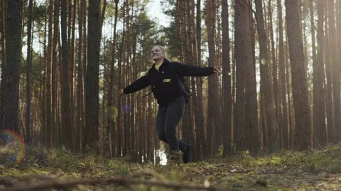 Girl spinning in the forest with a backpack Stock Footage 191906408
