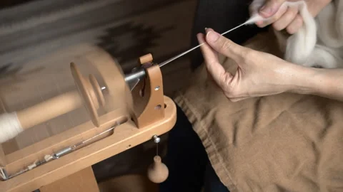 Girl Spinning Wool While Seated Stock Footage 255523330