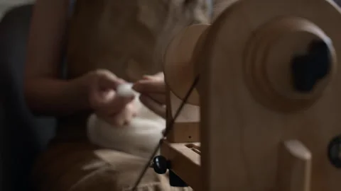 Girl Spinning Wool While Seated Stock Footage 255523924
