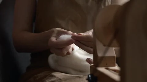 Girl Spinning Wool While Seated Stock Footage 255523950