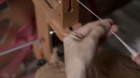 Girl Spinning Wool While Seated Stock Footage 255524083