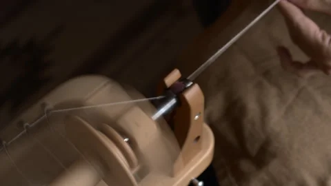 Girl Spinning Wool While Seated Stock Footage 255524402