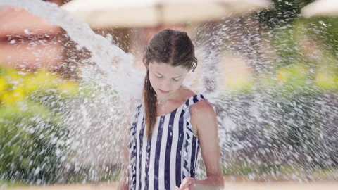 Girl Splashed By Water In Waterpark | Stock Video | Pond5