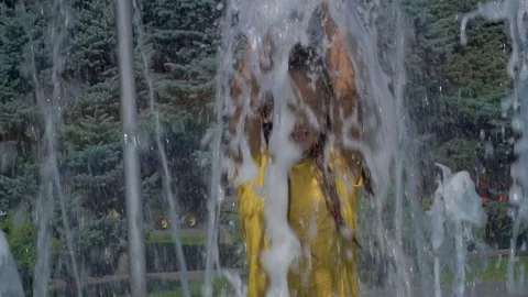 The girl splashes in the fountain Stock Footage