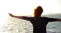 Girl Spreading Hands with Joy and Inspiration Facing the Sun. Spectacular HD Footage