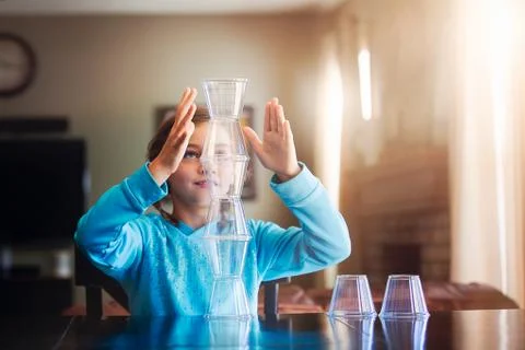 Girl stacking plastic cups Stock Photos