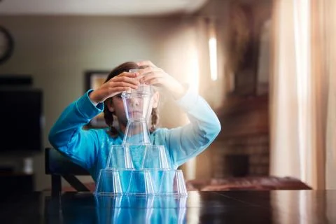 Girl stacking plastic cups Stock Photos