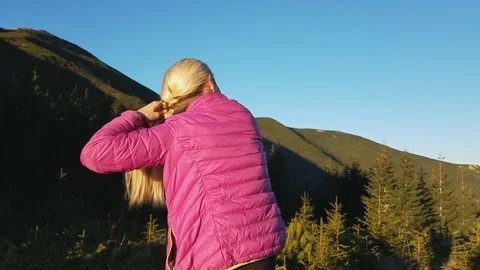 Girl standing back on the pathway and combing her hair . Slow motion. Stock Footage 97220267