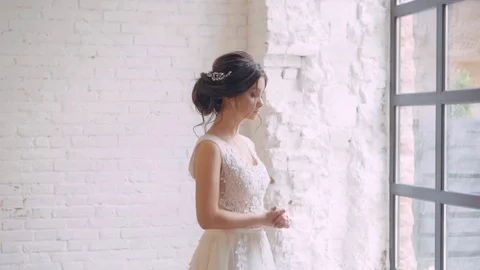 Girl standing at the big window thinking, dark-haired princess decides the fate Stock Footage 100193423