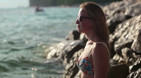 Girl standing on the cliff and splashed with water Stock Footage 52769238