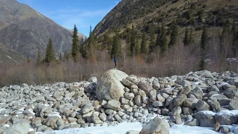 A girl is standing on a large stone between small stones Stock Footage 85167255