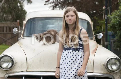 Girl Standing Near Cat On Vintage Car